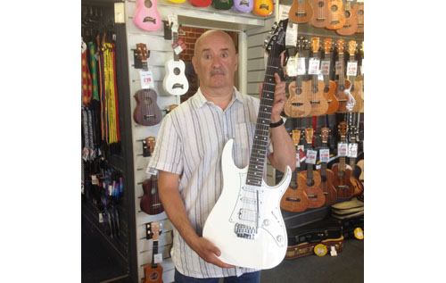 Win this awesome guitar signed by The Selecter (modelled here by a very startled festival director Steve Jenkins)