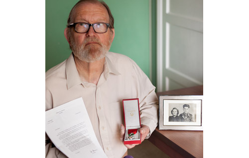 Alan Reeve with the letter from the French government and Légion d'honneur, which was awarded to the late Harold Reeve, who is shown in the photo (right) with his wife Stella. Photo: John Tym
