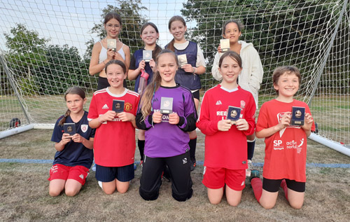 Red Rose girls' under 12 team with their promotion medals. Photo: Red Rose FC