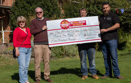 Les West, chair of the Bircham Centre charity trustees (second from left), with Reepham Festival team members (left to right) Brenda Gostling, Tom Crisp and Ben Pitcher. Photo: John Tym/Tympix