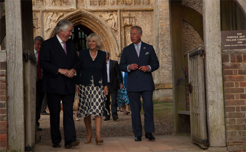 The Prince of Wales and the Duchess of Cornwall leaving St Peter and St Paul church, Salle, accompanied by the Lord-Lieutenant of Norfolk, Richard Jewson (left). Photo: John Tym