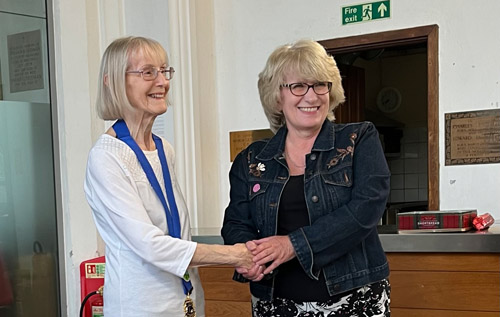 Outgoing Reepham Lions president Ann Graham (left) congratulating incoming president Brenda Gostling. Photo: Reepham Lions