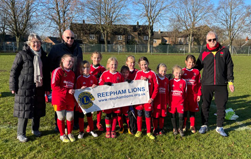 Liz and Barry Howes (left) with the Red Rose team and their lead coach, Paul Willmott. Photo: Reepham Lions