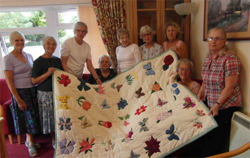 The Busy Fingers craft group have designed and sewn a unique quilt to be raffled in aid of Macmillan Cancer Support
