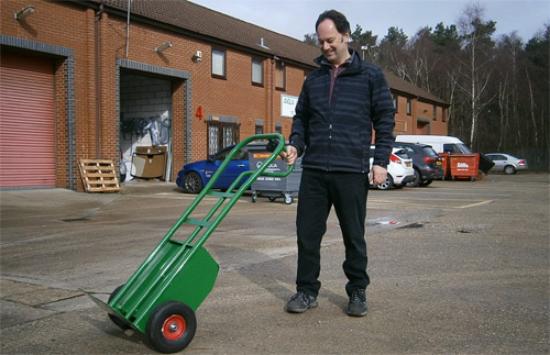 Mark Bridges, managing director of MGB Easy Handling, demonstrates the GoodsMan 100, a versatile powered sack truck designed and manufactured in the UK