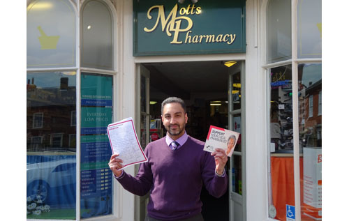 Reepham pharmacist Guppy Kular with the petition to stop cuts to pharmacy funding and support pharmacy services