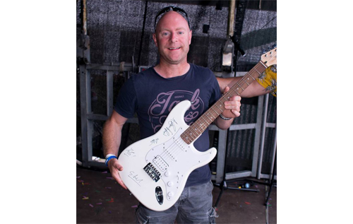 Lucky festivalgoer Jonny Marsh who won the charity guitar signed by headliners, Roachford. Photo: Tim Moll