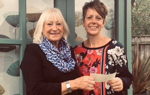 Gill Long of Reepham Lions (left) presents a cheque to Lisa Smith for the Hospice at Home Team.