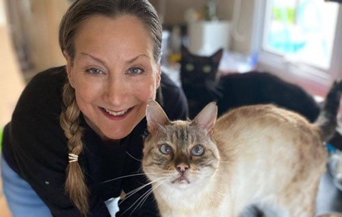 Registered veterinary nurse Miranda Luck at home with her cats. Photo: submitted