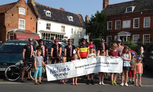 The eight 100-mile cyclists and children who saw them off, just before they departed from Reepham