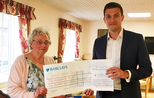 Moira Dye handing a cheque for '£1,185 to Jamie Kent of Nelson's Journey charity at Norfolk Oddfellows' May social evening. Photo: supplied