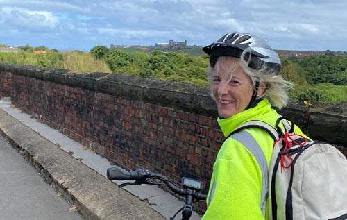 Sarah Morgan crossing the River Esk, with Whitby Abbey in the background. Photo: submitted