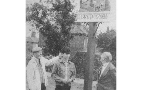 Mark Fairhurst (centre), designer of the original Bawdeswell village sign, pictured with parish council chairman John Ames (right) and parish clerk Charles Sparkes. Photo: EDP