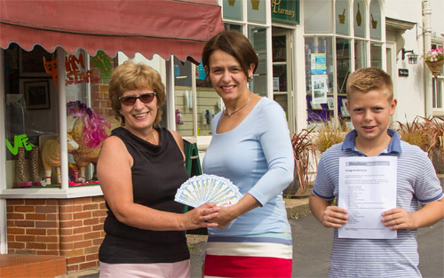 Left to right: Brenda Gostling, chairman of the Reepham Chamber of Commerce, with Angela Gibbs of Lyng, who won first prize in the Reepham Shopping Survey draw, and her son, Archie. Photo: John Tym www.tympix.com